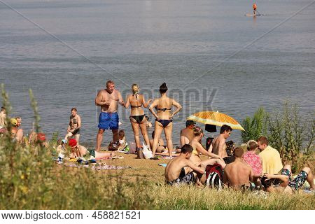 Moscow, Russia - July 2022: People Sunbathing On A Beach On Background Of Moscow River In Strogino, 