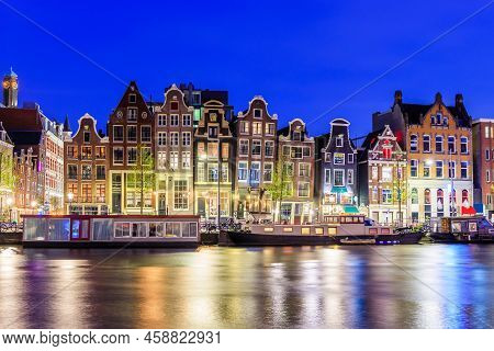 Amsterdam, Netherlands. Colorful Dancing Houses At The Damrak Canal.