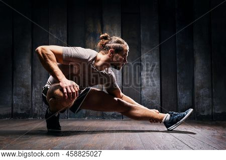 Active Athlete Do Exercises On The Floor, Intense Training On Black Background. Strong Sportsman In 