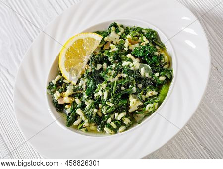 Spanakorizo, Greek Spinach And Rice Pilaf With Lemon, Dill, Spring Onion In White Bowl On White Wood