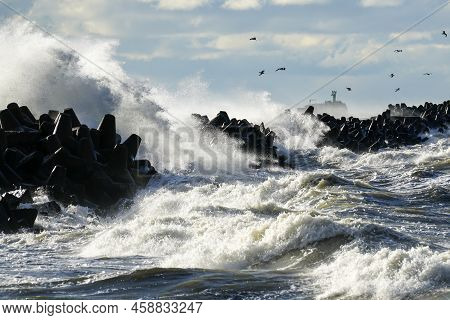 Large Waves Created During Stormy Weather Crash Against The Breakwater Concrete Tetrapods With High 
