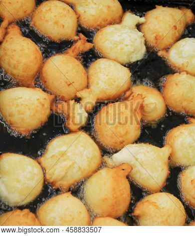 A Whole Lot Of Curd Balls In A Boiling Oil Bath.
