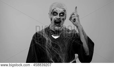Eureka. Inspired Sinister Man Halloween Crazy Zombie With Bloody Wounded Scars Face Make Gesture Rai