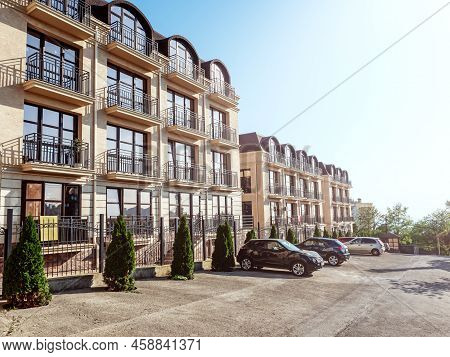 Russia, Sochi 03.07.2020. New Four-storey Apartment Building. Cars Parked At The Apartment New Low-r