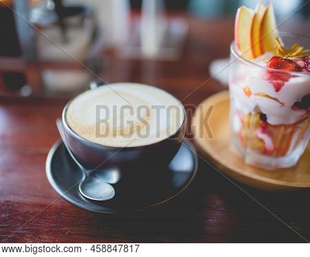 Picture Of A Cup Of Coffee And Homemade Fruit Yoghurt With Strawberry Jam, Apple And Conflake