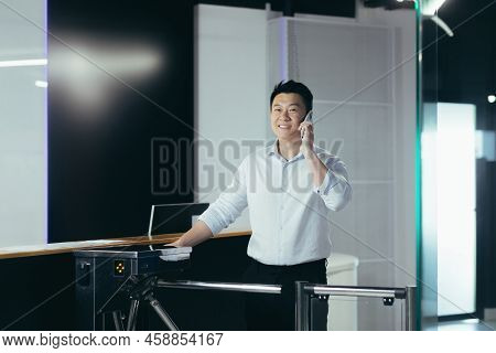 A Young Handsome Asian Businessman Passes Through The Security Desk And Pass In The Morning To The O