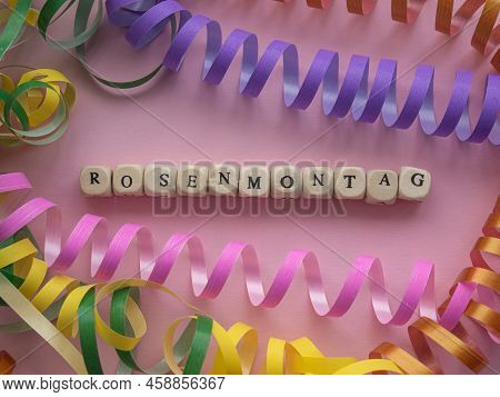 German Text Rosenmontag, Translate Carnival Monday. Rosenmontag In Wooden Cubes On Pink Background W