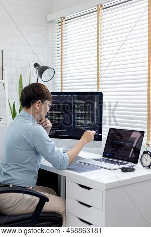 Professional development programmers are laying out a structure or draft on paper in preparation for