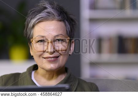 Business Mature Woman Looking At Camera In Library Office. Attractive Middle Aged Woman Portait.