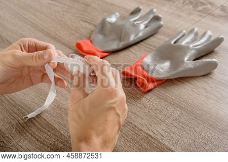 Male Specialist Repairing Plumbing In The House, Close-up Photo Of A Fum Tape In His Hands