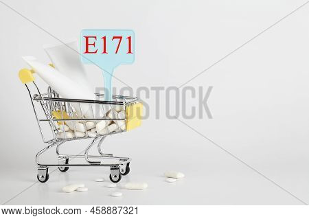 Titanium Dioxide, E171, Dangerous Additive Concept. Gum, Pills, Toothpaste, Cream In Basket And Sign