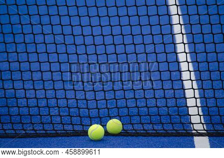 Blue Paddle Tennis Court, Two Balls Next To The Net And The Line