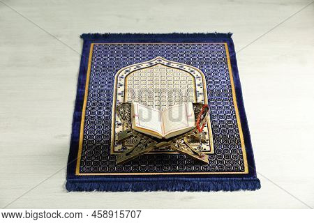 Rehal With Open Quran And Misbaha On Muslim Prayer Rug Indoors