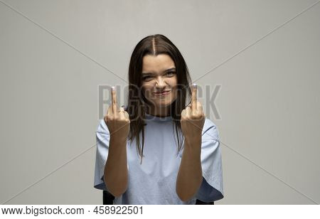 Portrait Of Rude Vulgar Woman Showing Middle Fingers, Impolite Gesture Of Disrespect, Looking With A