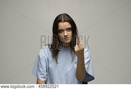 Portrait Of Crazy Angry Brunette Woman Wearing Casual Style Beige T-shirt Showing Middle Finger With