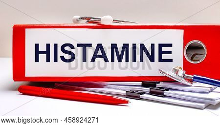 On The Desktop Is A Stethoscope, Documents, A Pen, And A Red File Folder With The Text Histamine. Me