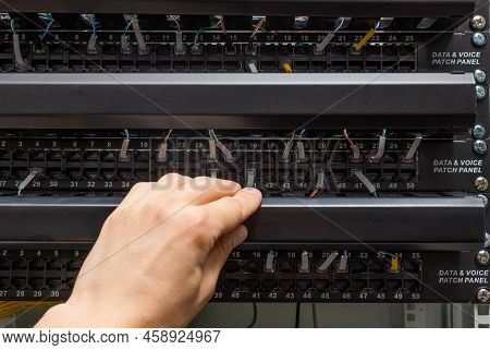 Closeup View Of Engineer Openenning Data Voice Patch Panel For Switching Cables. Communication And N