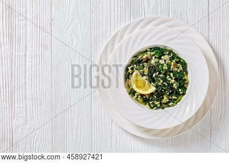 Spanakorizo, Greek Spinach And Rice Pilaf With Lemon, Dill, Scallion In White Bowl On White Textured
