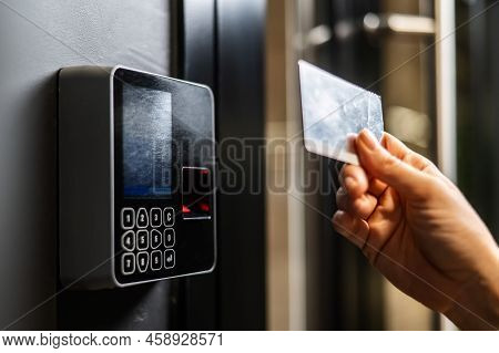A Woman Opens The Door With A Plastic Card. Modern Keyless Entry Lock.