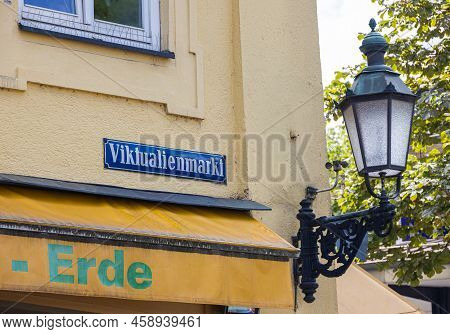 Munich, Germany - July 6, 2022: Street Sign Of The Viktualienmarkt With A Historic Street Lamp Besid