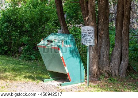 Eagle River, Mi - June 22, 2022: Animal Proof Trash Receptacle In Public Park