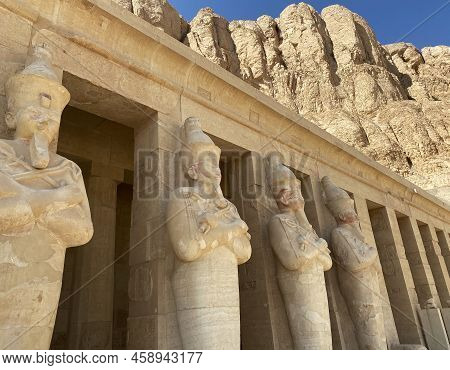 Photo Of Ancient Egyptian Architecture. Mountains In The Background.