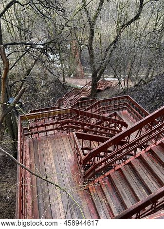 Staircase In The Park. The Photo Shows Red Wooden Stairs In The Park.