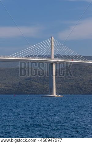 Beautiful Bridge Across The Sea To Peljesac Peninsula In Croatia. There Are Dramatic Clouds In The S