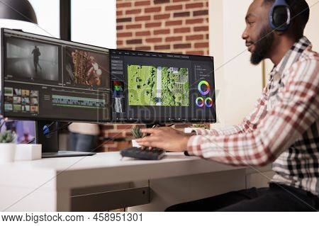 Multimedia Editor Using Software To Edit Video Footage On Multiple Monitors At Home, Editing Movie W