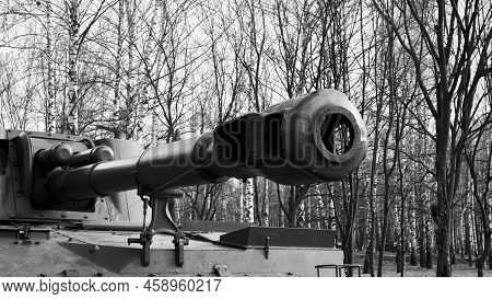 Russian Howitzer Barrel Close-up. Black And White Photo Of A Russian Howitzer On A Background Of Tre