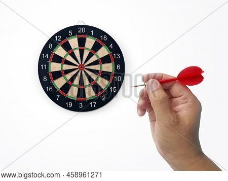 Human Hand Is Throwing The Darts Target To The Darts Board. A Man's Hand Throws A Dart At The Target