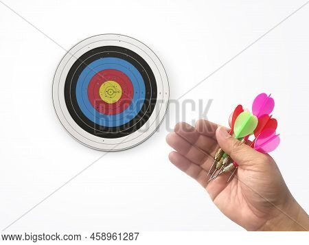Human Hand Is Throwing The Darts Target To The Darts Board. A Man's Hand Throws A Dart At The Target