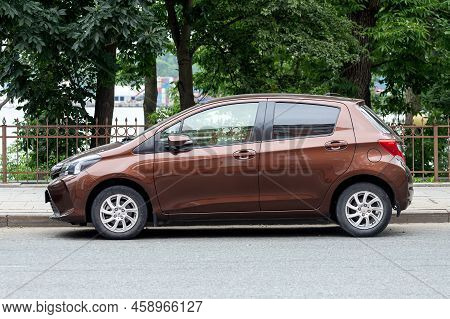 Vladivostok, Russia - July 14, 2022:   Brown Toyota Vitz  Is Parked  On The Street On A Warm Summer 