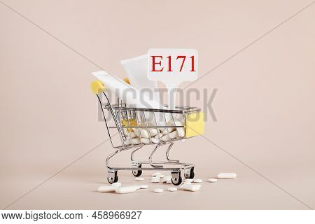 Titanium Dioxide, E171, Dangerous Additive Concept. Gum, Pills, Toothpaste, Cream In Basket And Sign