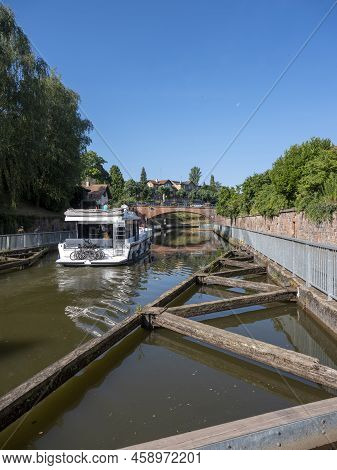 Boat In Canal Between Marne And Rhine In French City Of Saverne Under Blue Summer Sky In French Vosg