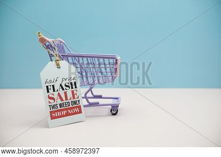 Flash Sale Text Message On Price Tax With Shoppint Trolley Cart On Blue And Pink Background
