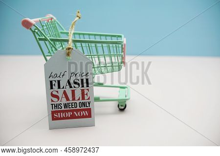 Flash Sale Text Message On Price Tax With Shoppint Trolley Cart On Blue And Pink Background