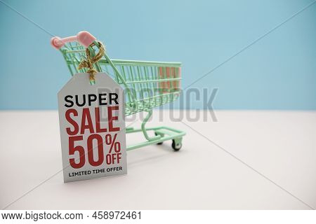 Super Sale 50% Off Text Message On Price Tax With Shoppint Trolley Cart On Blue Andp Pink Background