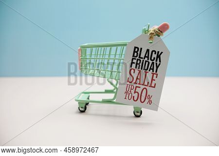 Black Friday Sale Up To 50% Text Message On Price Tax With Shoppint Trolley Cart On Blue Andp Pink B
