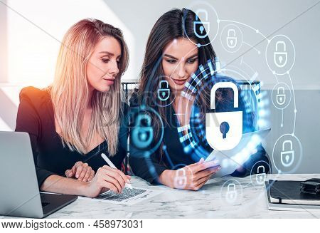 Two Office Woman Work Together, Sign Contract And Looking At Tablet. Glowing Padlock Icon With Circu