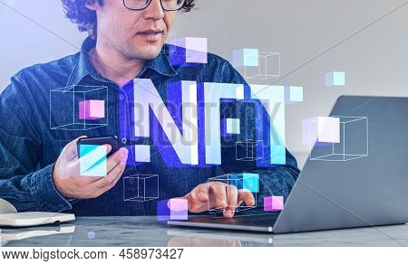 Businessman Typing On Laptop, Using Smartphone. Digital Hologram Of Nft, Data Blocks And Virtual Art