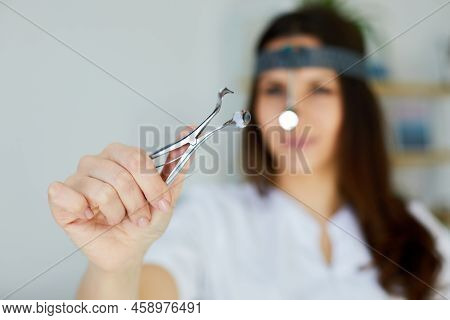 Instruments Ent Doctor Close-up With Hand. Therapist. Female Ent Doctor Holding A Tool. Nasal Specul