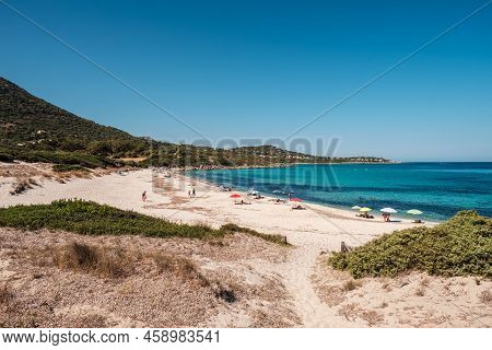 Holidaymakers Enjoy The Turquoise Mediterranean Sea At Bodri Beach In The Balagne Region Of Corsica