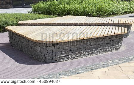 Wooden Benches From Gabion Baskets With Stones Inside. Wood Mounted On Gabions. Benches Of Modern De