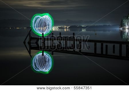 An image of a green heart of light at the Starnberg Lake in Germany