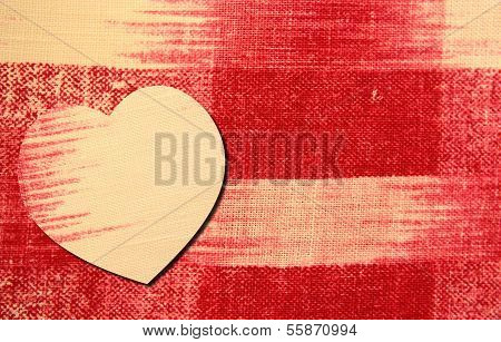 Heart on red and white linen background