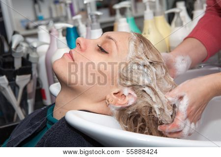 hair washing at a hairdressing salon, young caucasian girl 