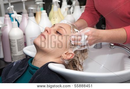 hair washing at a hairdressing salon, young caucasian girl 