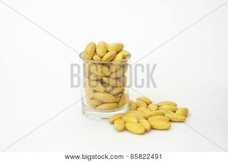 Herb capsule spilling out of a cup