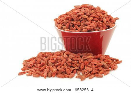 dried goji berries(Lycium Barbarum - Wolfberry)  in a red bowl on white background